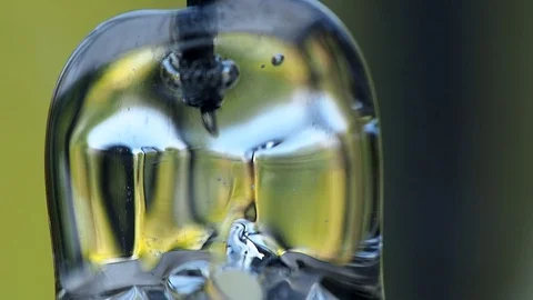 Hypnotic reflections pulsating light from radiometer blue green yellow Stock Footage 94787557