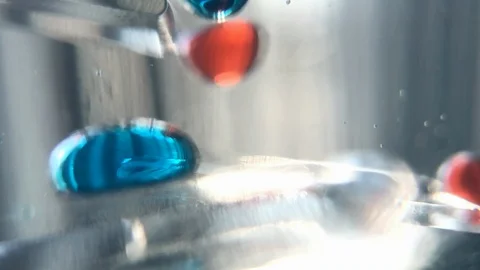 Hypnotic slow motion liquid bubbles dropping through frame Stock Footage 100607037