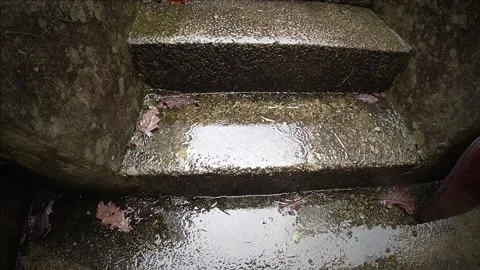 Hypnotic slow motion rain splashing on old concrete steps. Stock Footage 137230959