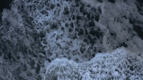 Hypnotic slow-motion wave crashes after storm, top-down aerial Stock Footage 112707063