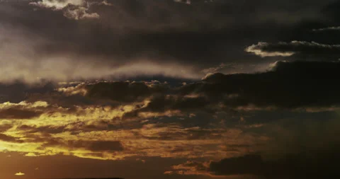 Hypnotic storm clouds morph and meld with the changing light at the day’s end. 動画素材 286762063