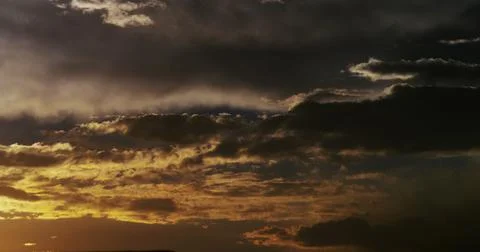 Hypnotic storm clouds morph and meld with the changing light at the day’s end. 스톡 사진