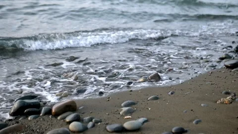 Hypnotic Tide Pull – Extreme Close-Up of Waves Draining Through Pebbles. Stock Footage 326225255