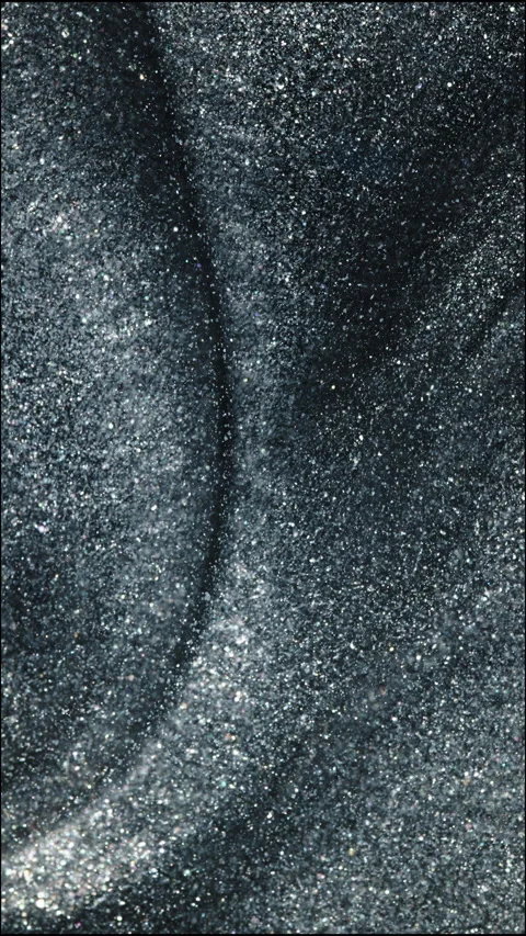 Hypnotic Vertical Macro Shot of Glittery Liquid Mixing in Motion Stock Footage 329144694