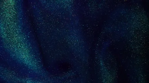 The Hypnotic Waves of Gold Dust Particles in Blue Liquid With Green Tints. Video stock 241529165