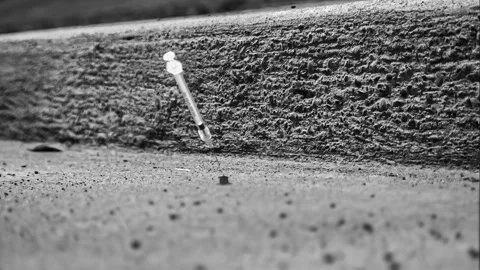 Hypodermic Needle Dropping Into City Gutter Stock Footage 242547259