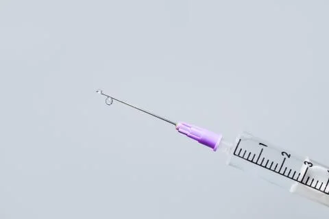 Hypodermic needle ejecting clear liquid - isolated syringe Stock Photos