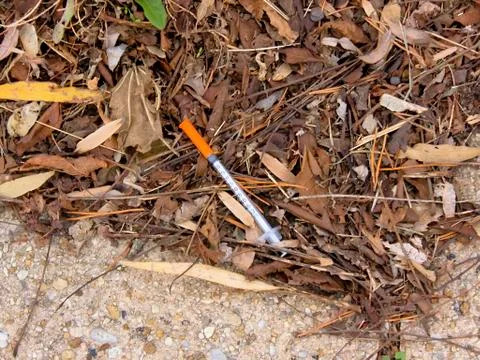 Hypodermic needle on street Foto stock