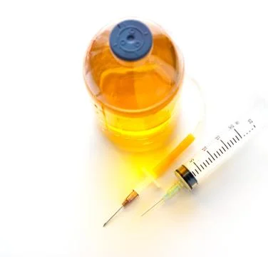 Hypodermic syringe and saline solution on colorful Fotos Stock