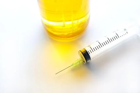 Hypodermic syringe and saline solution on colorful 스톡 사진