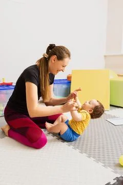Hypotonia in babies, muscle weakness. Testing of toddler reflexes with use of Stock Photos