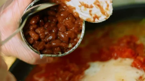I add a can of Mexican beans to the roasted turkey. Cook chili con carne Stock Footage 169489707