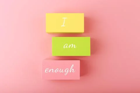 I am enough concept with words written on colorful rectangles against bright Stock Photos