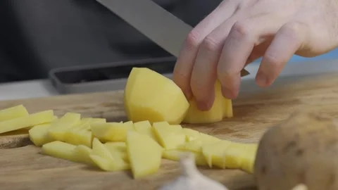 I am getting ready to chop fresh potatoes for delicious recipes that everyone Stock Footage 305280369