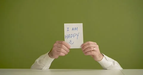 I am Happy  - The man's mini picks up a sheet where it is written Stock Footage 267090117