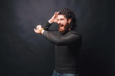 I am late, man looking afraid at smartwatch over dark background 스톡 사진