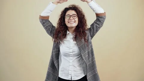 I am safe. Happy contented adult woman showing the roof with her hands above her Stock Footage 150439360