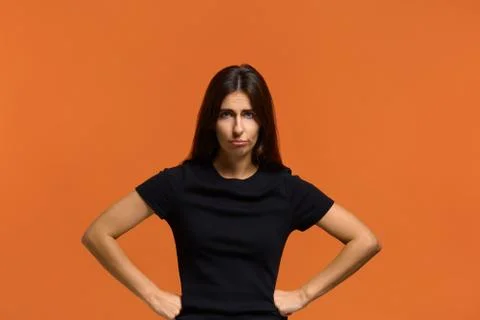 I am very angry. Portrait of serious caucasian woman in black t-shirt, holdin Stock-Fotos
