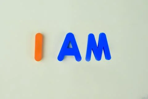 I AM which is written in different colored letter blocks on a white backgroun Stock Photos