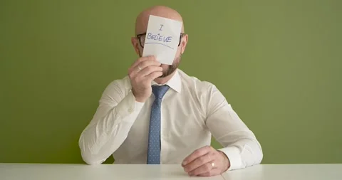 I believe  - A man presents a note with the word Stock Footage 267089005