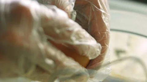 I break an egg and add it to the ingredients. Ingredients for the dough with a Stock Footage 165363443