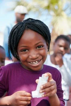I can breathe easy now. Portrait of a little girl holding an asthma inhaler a Stock Photos