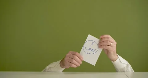 I CAN The man's mini picks up a sheet where it is written Stock Footage 267090253