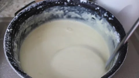 I check the consistency of the pancake batter 動画素材 155144898