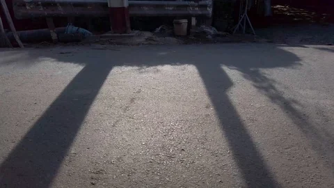 I dark background and long shadows across the road allow for close up of Stock Footage 115469779