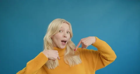 I did it myself. Joyful naughty young blonde woman in yellow sweater points to Video stock 150906374