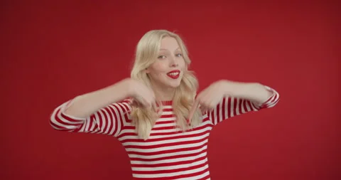 I did it myself. Joyful naughty young blonde woman in yellow sweater points to Stock Footage 150907384