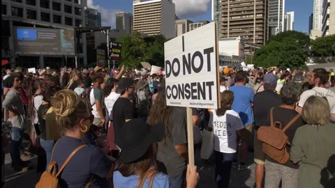 'I DO NOT CONSENT' placard at Anti Vaccine demo slow motion 4K Video stock 157410767