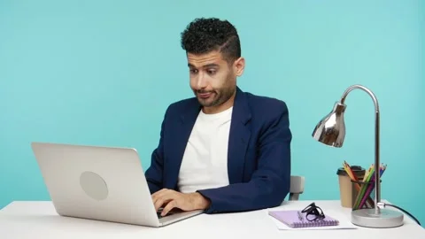 I dont know. Frustrated bearded man in business suit working on laptop in Stock Footage 142293175