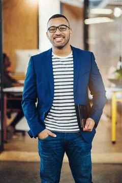 I enjoy proving others wrong. a handsome young businessman standing in an office Stock Photos
