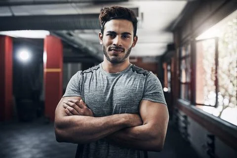 I enjoy using my muscles. Portrait of a handsome young man at the gym for a Stock Photos