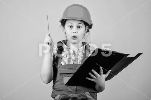 I have an idea. Safety expert. Future profession. small girl repairing in Stock Photos