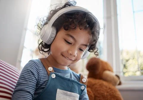 I hope youll never find the rainbows end. an adorable young boy using headphones Stock Photos
