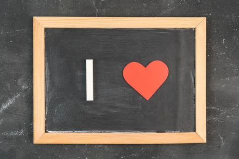 I Love. Text on a chalkboard using white chalk and a red heart symbol, top vi Stock Photos