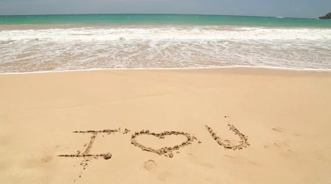 I LOVE U written in the beach sand washed aways by waves. Stock Footage