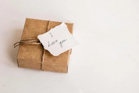 I love you note on small craft gift box white wooden background. Concept of Stock Photos