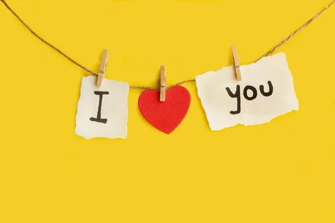 I love You phrase Made with texto and a red hearts hanging from a thread Stock Photos