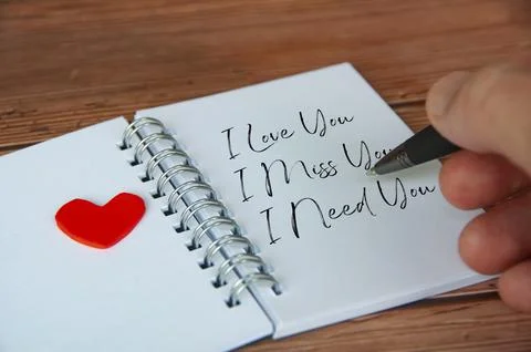 I love you text on notepad with wooden cover and pen background. Romance and Stock Photos