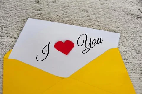 I love you text on notepad in yellow envelope. Stock Photos