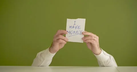 "I make Money " The man's mini picks up a sheet where it is written Stock Footage 267090561