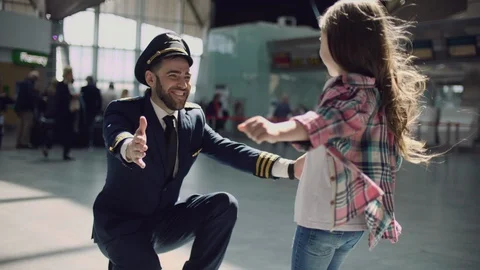 I missed you, dad! Handsome young male pilot in uniform is meeting his little Stock Footage 109147332