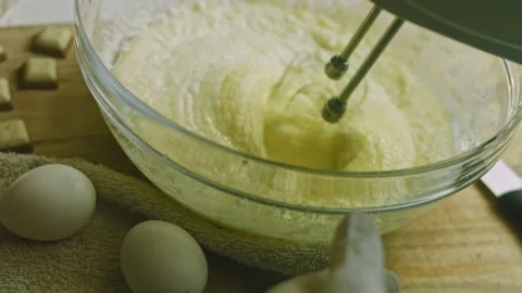 I mix the baking ingredients with the mixer. Christmas atmosphere with lights in Stock Footage 169164841