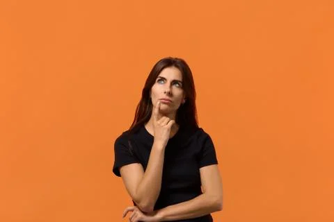 I need to find a solution. Attractive caucasian woman in black t-shirt looks  Stock Photos