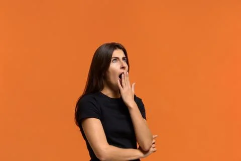 I need more time to rest. Sleepy caucasian woman in black t-shirt yawns as be Stock Photos