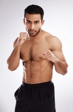 I never pull my punches. a young man practicing his punches against a studio Stock Photos