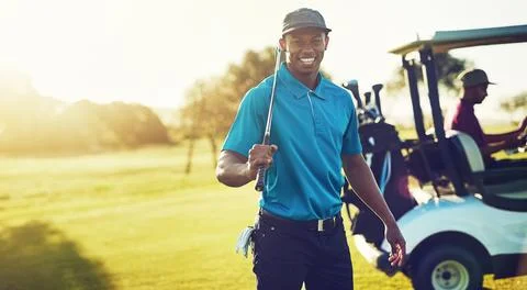 I only golf on days that end in Y. a golfer holding his club with a buggy Stock-Fotos